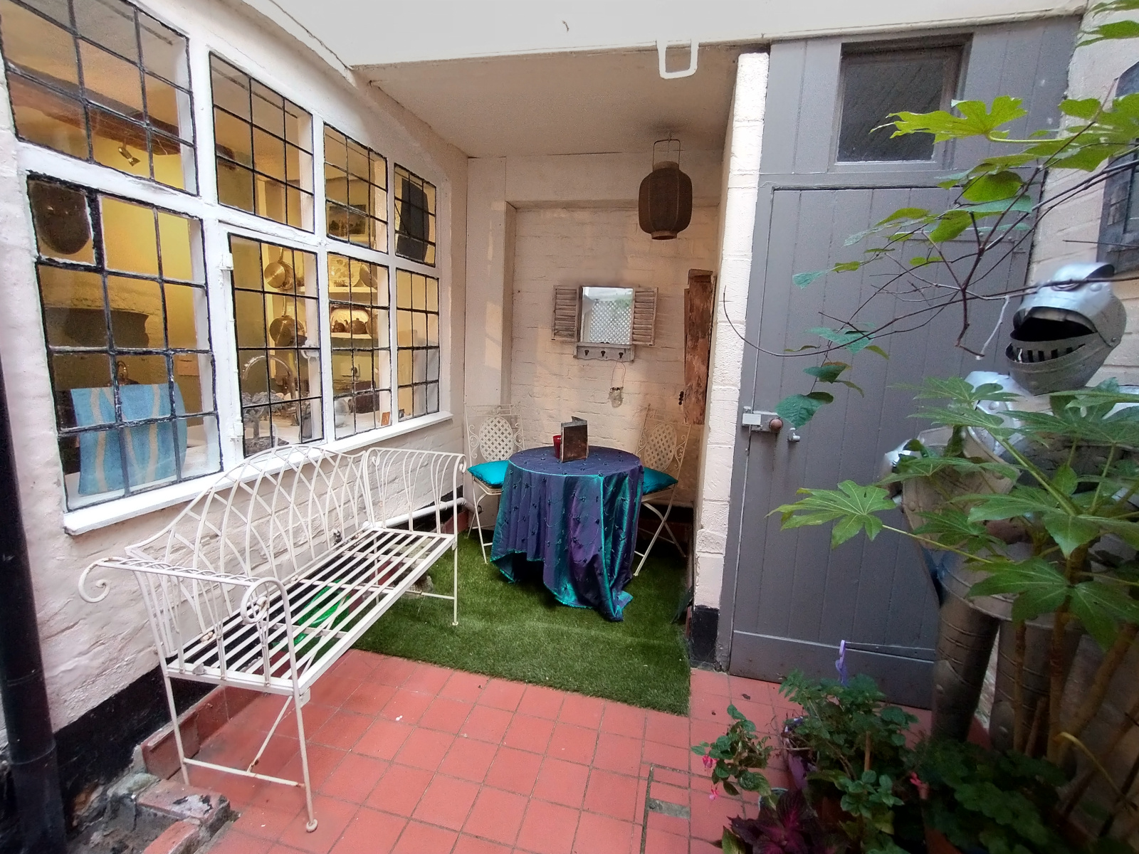 Outer courtyard with space to sit… and a stray suit of armour hiding in the greenery