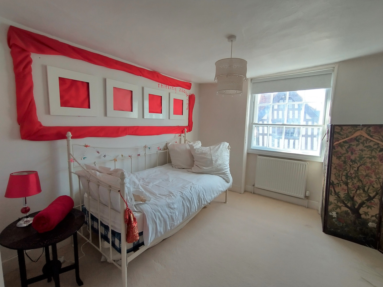 Single bedroom with comfortable bed and hidden clues